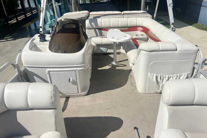 Slide: The Image of 2006 Princecraft Versailles 22 LP-SS pontoon boat interior with white seating and table. - 9