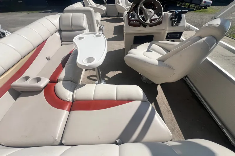 Slide: The Image of 2006 Princecraft Versailles 22 LP-SS pontoon boat interior with white and red seating. - 10