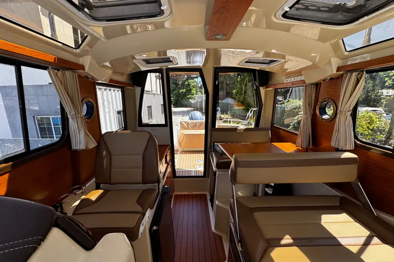 Slide: The Image of Interior of 2020 Ranger Tugs R-23 boat with seating and wood accents. - 6