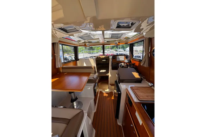 Slide: The Image of Interior of 2020 Ranger Tugs R-23 boat, featuring wood accents and modern amenities. - 4