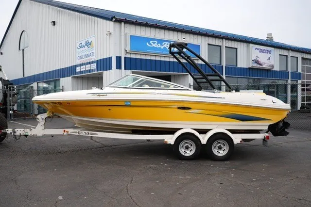Slide: The Image of Yellow 2006 Sea Ray 205 Sport boat on trailer outside dealership. - 15
