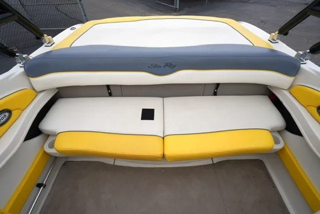 Slide: The Image of 2006 Sea Ray 205 Sport boat interior with yellow and white seating. - 3
