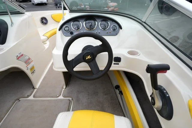 Slide: The Image of 2006 Sea Ray 205 Sport boat interior with steering wheel and dashboard controls. - 5