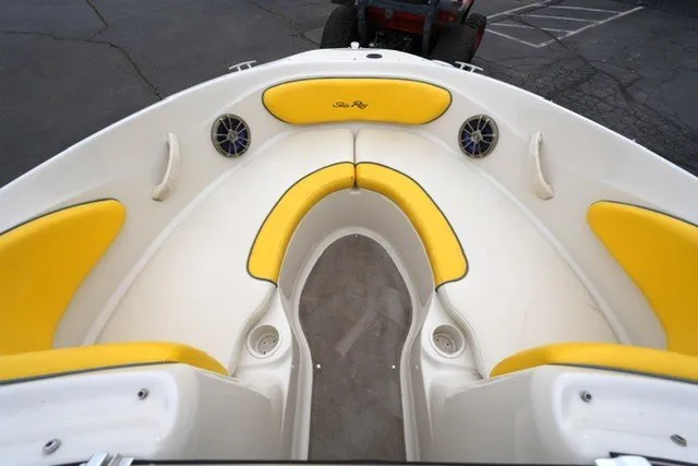 Slide: The Image of 2006 Sea Ray 205 Sport boat interior with yellow seating and speakers. - 7