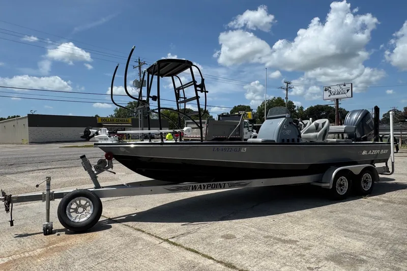 The Image of 2018 Blazer Bay 2420 GTS boat on trailer, parked outdoors under a clear sky. - 1