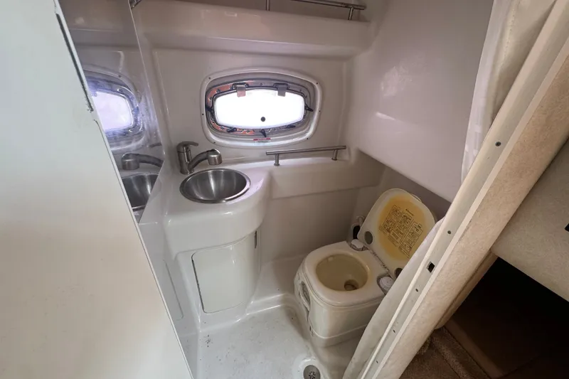 Slide: The Image of Compact bathroom in 2006 Sea Ray Sundancer 260 boat with sink and toilet. - 16