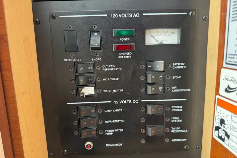 Slide: The Image of Electrical control panel on a 2006 Sea Ray Sundancer 260 boat, featuring AC and DC switches. - 20