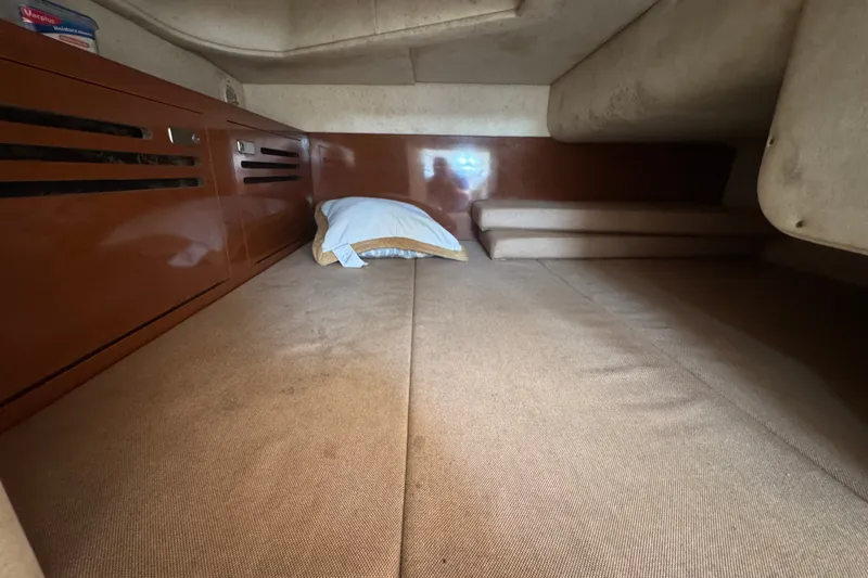 Slide: The Image of Interior cabin of 2006 Sea Ray Sundancer 260 with cozy bedding and wooden cabinetry. - 18