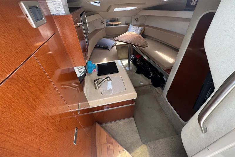Slide: The Image of Interior of 2006 Sea Ray Sundancer 260 boat with kitchenette and seating area. - 14