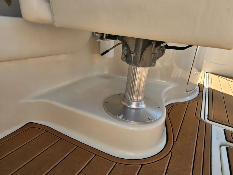 Slide: The Image of Close-up of a boat deck with wooden flooring and a metal post. - 38
