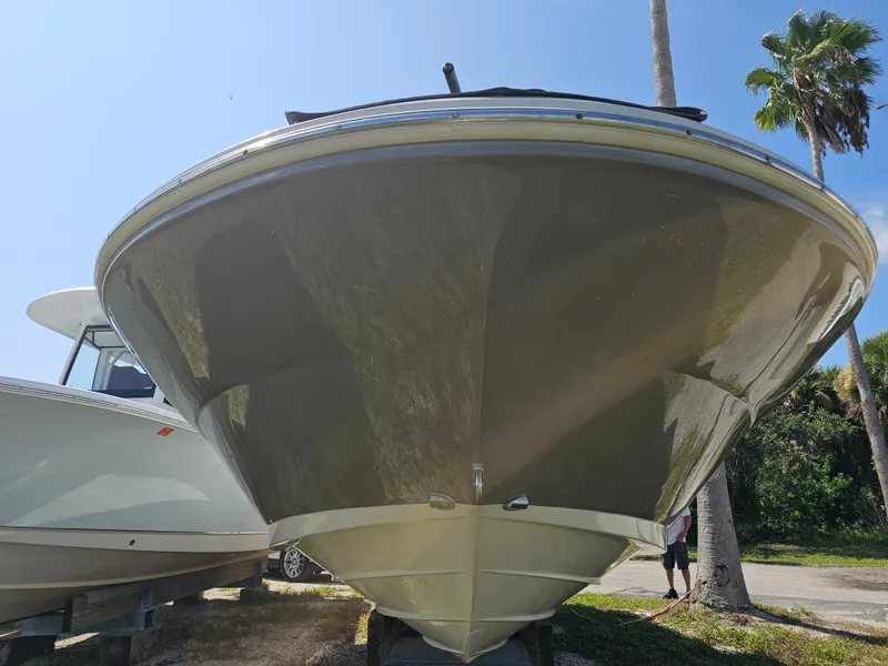 Slide: The Image of The 2006 Sea Ray 270 Sundeck is on a trailer, surrounded by palm trees and a clear sky. - 49