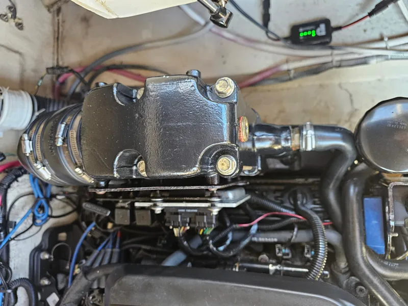 Slide: The Image of Close-up of an engine compartment with various wires and components. - 20