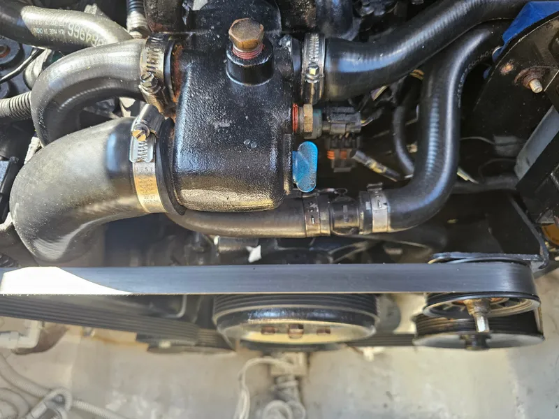 Slide: The Image of Close-up of a boat engine with hoses and belts, well-maintained and clean. - 18