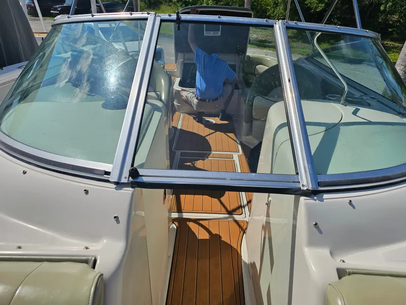 Slide: The Image of A 2006 Sea Ray 270 Sundeck with an open cockpit and wooden flooring. - 33