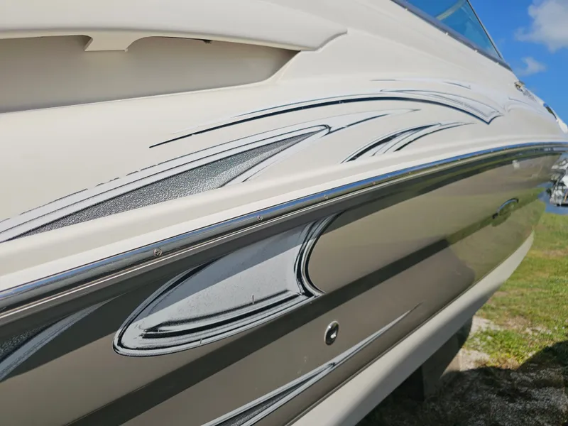 Slide: The Image of Close-up of the sleek side of a 2006 Sea Ray 270 Sundeck with stylish graphics. - 48