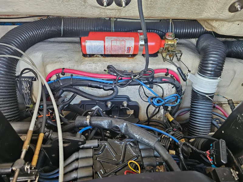 Slide: The Image of The engine compartment of a 2006 Sea Ray 270 Sundeck with cables and a fire extinguisher. - 21