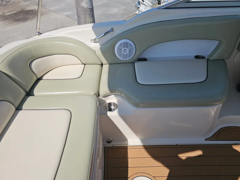 Slide: The Image of The 2006 Sea Ray 270 Sundeck features an elegant seating area with beige and green upholstery. - 39