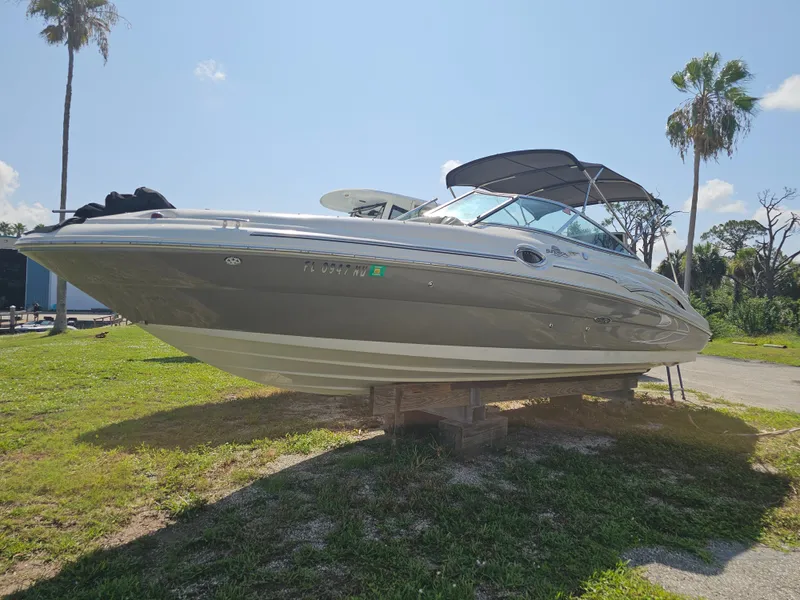 The Image of A 2006 Sea Ray 270 Sundeck is on grass. It features a black canopy. - 0