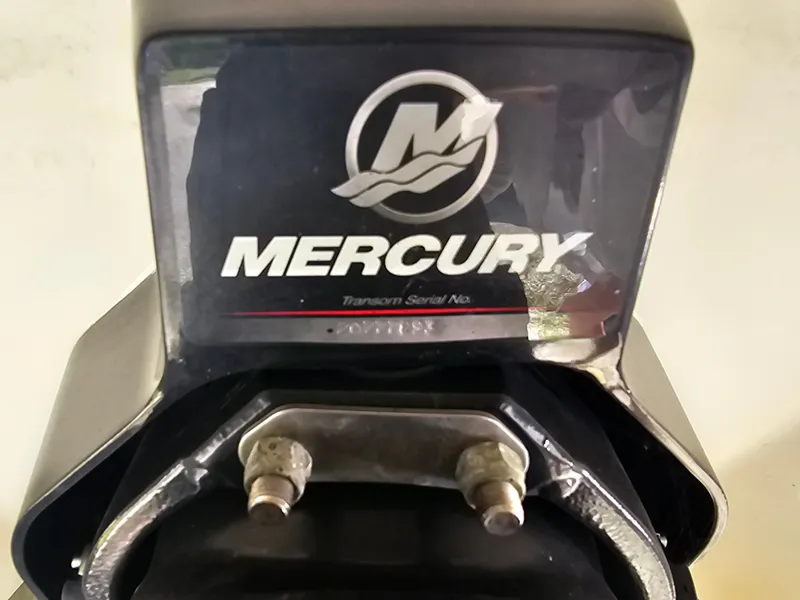 Slide: The Image of Close-up of a Mercury engine part with logo and serial number. - 46