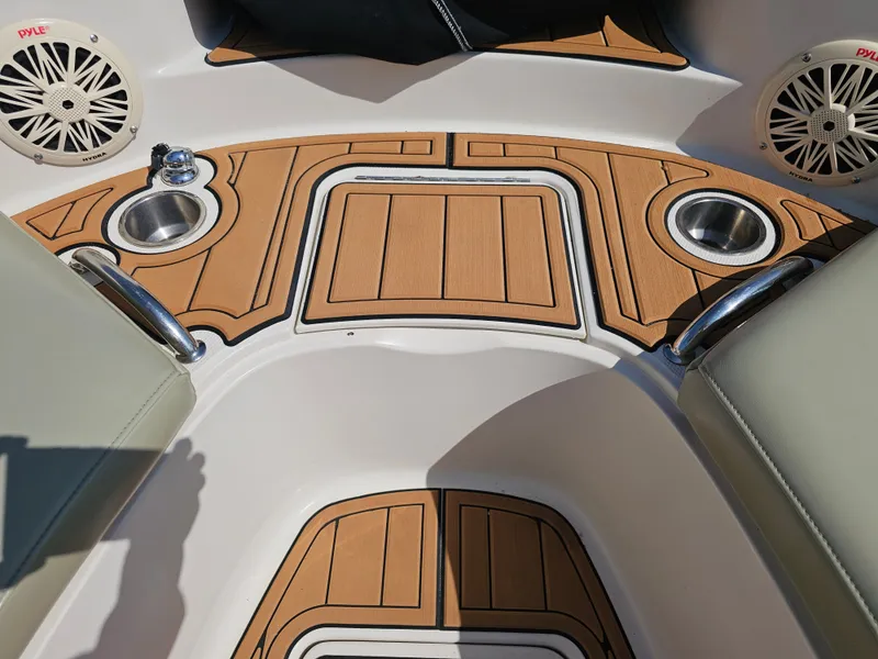 Slide: The Image of The image shows the cockpit of a 2006 Sea Ray 270 Sundeck with wood flooring and speakers. - 30