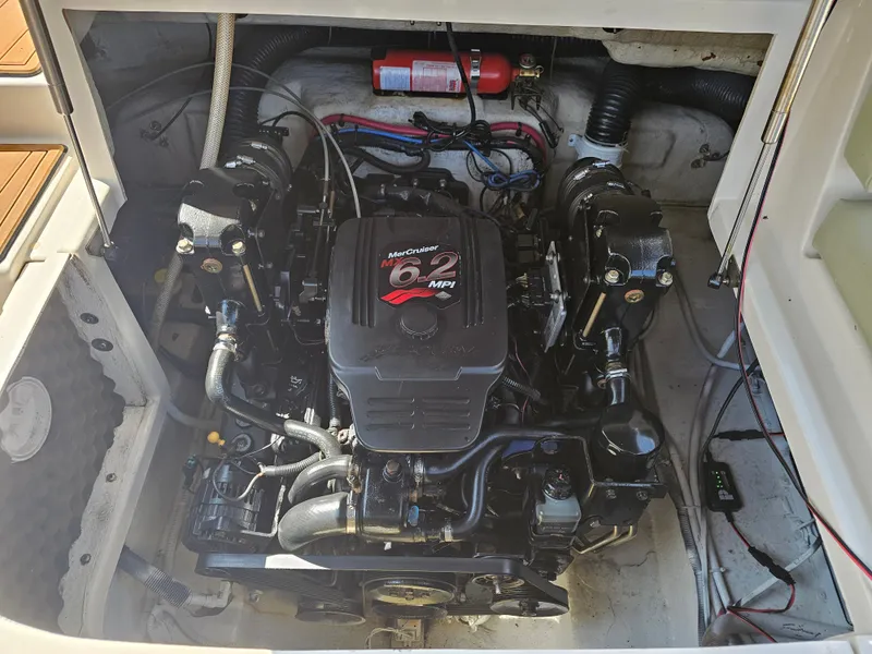Slide: The Image of The engine compartment of a 2006 Sea Ray 270 Sundeck features a MerCruiser 6.2 MPI engine. - 13