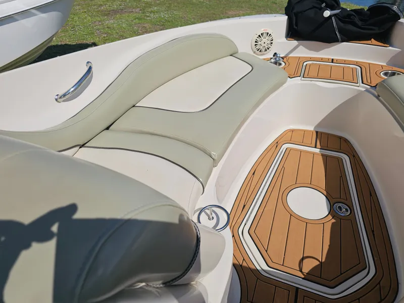 Slide: The Image of The image shows the cockpit of a 2006 Sea Ray 270 Sundeck with beige upholstery and wood flooring. - 32