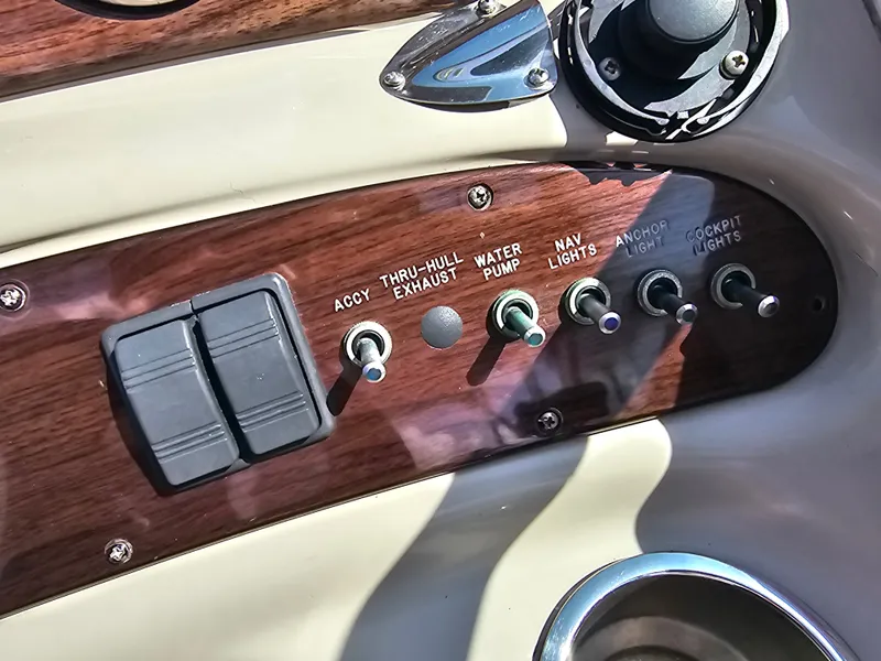 Slide: The Image of Close-up of a 2006 Sea Ray 270 Sundeck dashboard with various switches. - 36