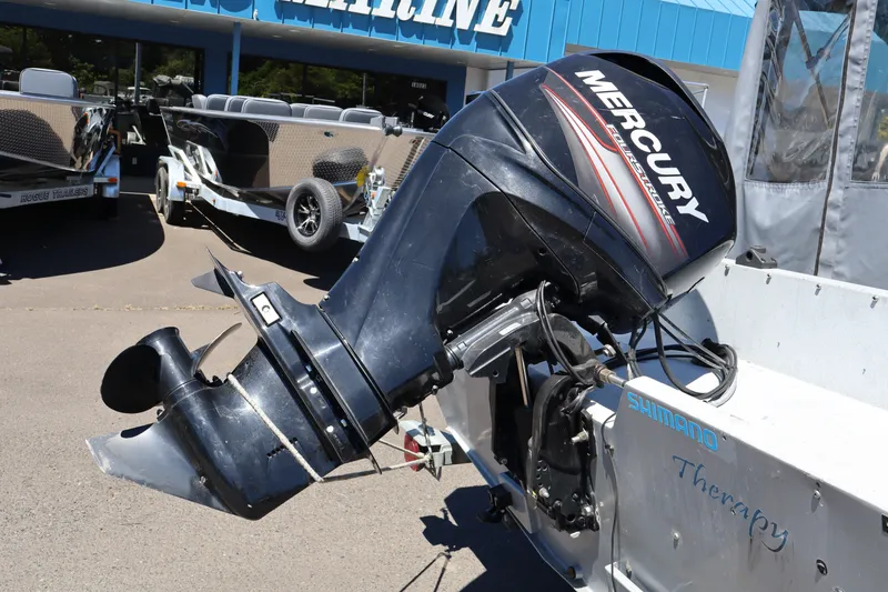 Slide: The Image of 2005 Jetcraft 1625 SK boat with Mercury outboard motor at a marine dealership. - 5