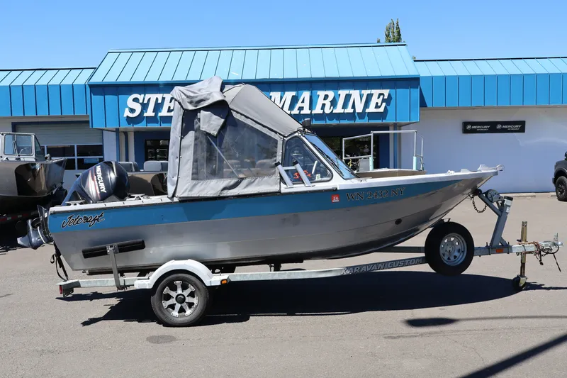 The Image of 2005 Jetcraft 1625 SK boat on trailer outside marine store. - 1