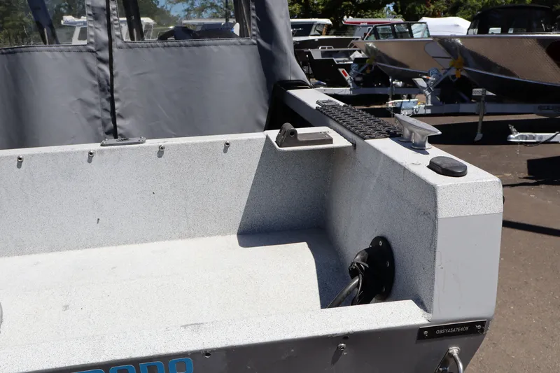 Slide: The Image of 2005 Jetcraft 1625 SK boat interior with gray upholstery and outdoor setting. - 6
