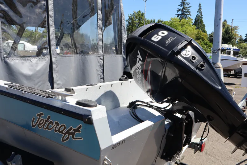 Slide: The Image of 2005 Jetcraft 1625 SK boat with Mercury 60 CST outboard motor, parked outdoors. - 7