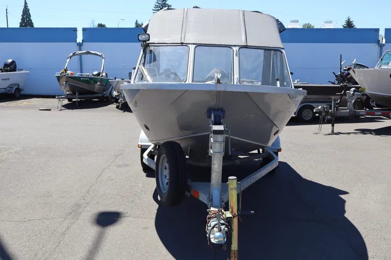 Slide: The Image of 2005 Jetcraft 1625 SK boat on trailer in parking lot. - 2