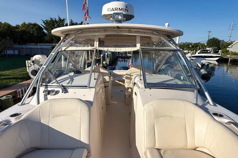 Slide: The Image of 2012 Grady-White Freedom 307 boat with Garmin equipment, docked in a serene marina. - 35