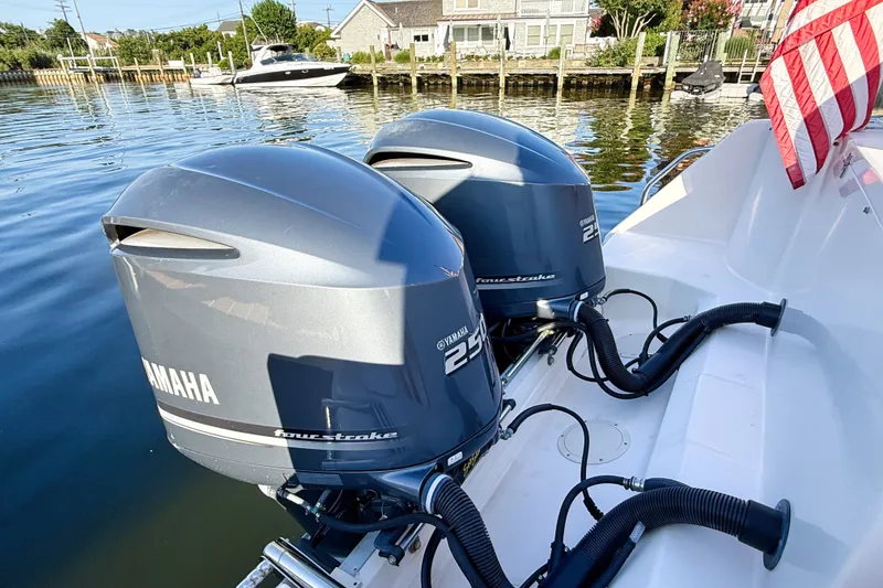 Slide: The Image of 2012 Grady-White Freedom 307 with twin Yamaha 250 outboard engines docked by waterfront homes. - 12