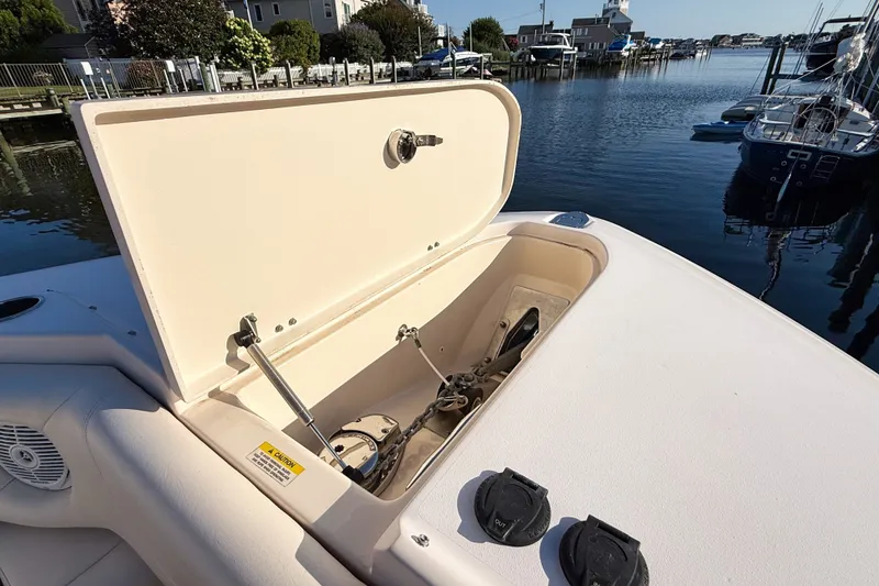 Slide: The Image of 2012 Grady-White Freedom 307 boat with open storage compartment by the water. - 34