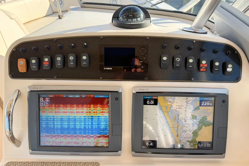 Slide: The Image of Dashboard of a 2012 Grady-White Freedom 307 boat with navigation displays. - 28