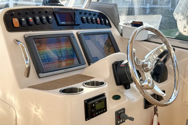 Slide: The Image of Helm of 2012 Grady-White Freedom 307 boat with advanced navigation displays and controls. - 27