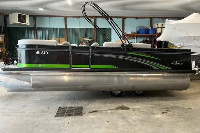 The Image of 2022 Angler Qwest 820XRE Cruise LT pontoon boat in a garage setting. - 0