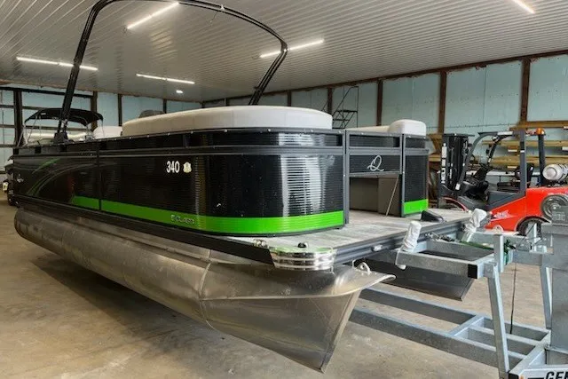 Slide: The Image of 2022 Angler Qwest 820XRE Cruise LT pontoon boat in a storage facility. - 1