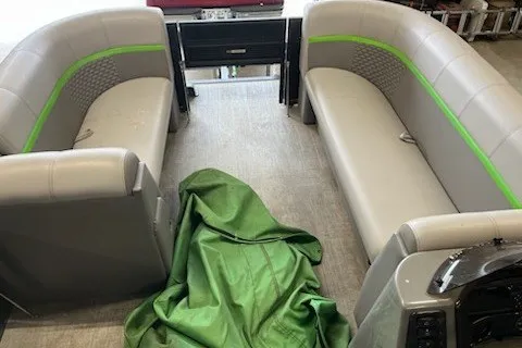 Slide: The Image of 2022 Angler Qwest 820XRE Cruise LT interior with gray seating and green accents. - 30