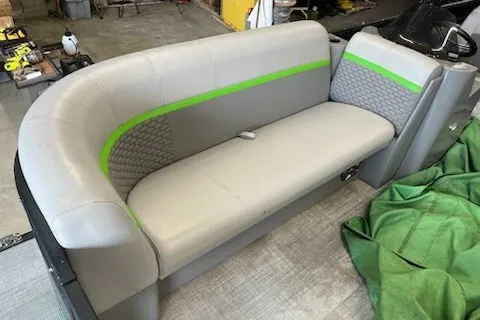 Slide: The Image of 2022 Angler Qwest 820XRE Cruise LT boat seat with gray upholstery and green accents. - 19