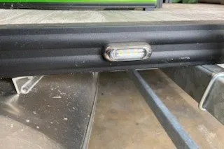 Slide: The Image of 2022 Angler Qwest 820XRE Cruise LT trailer detail with LED light and metal frame. - 13