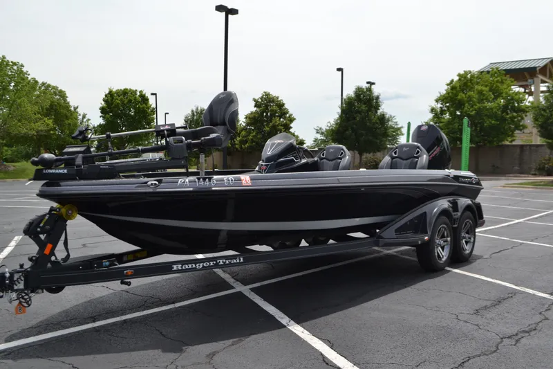 Slide: The Image of 2023 Ranger Z521R boat on trailer in parking lot, featuring sleek design and advanced equipment. - 2
