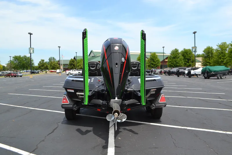 Slide: The Image of 2023 Ranger Z521R boat in parking lot, rear view with motor and green accents. - 6