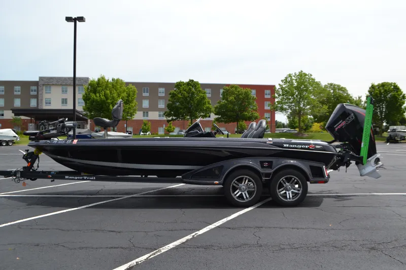 The Image of 2023 Ranger Z521R boat in parking lot, side view, with trailer and outboard motor. - 0