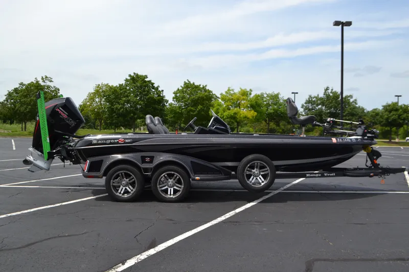 Slide: The Image of 2023 Ranger Z521R bass boat in parking lot, side view with trailer. - 1