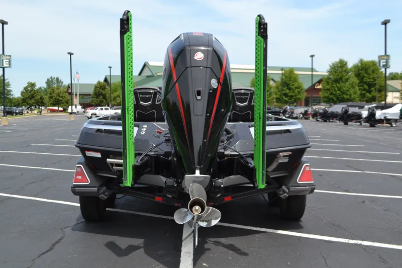 Slide: The Image of 2023 Ranger Z521R boat in parking lot, rear view with motor and green poles. - 7