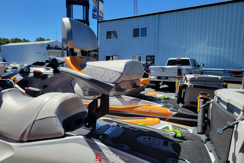 Slide: The Image of 2022 Sea-Doo FishPro Trophy 170 jet ski with fishing accessories, parked outdoors. - 21