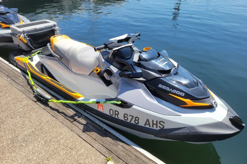 The Image of 2022 Sea-Doo FishPro Trophy 170 jet ski docked on calm water. - 0