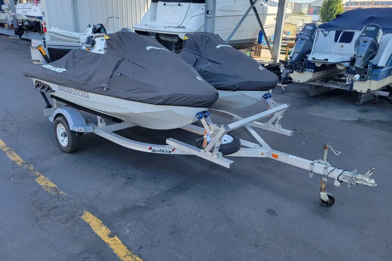 Slide: The Image of 2022 Sea-Doo FishPro Trophy 170 on trailer, covered, parked in marina. - 23